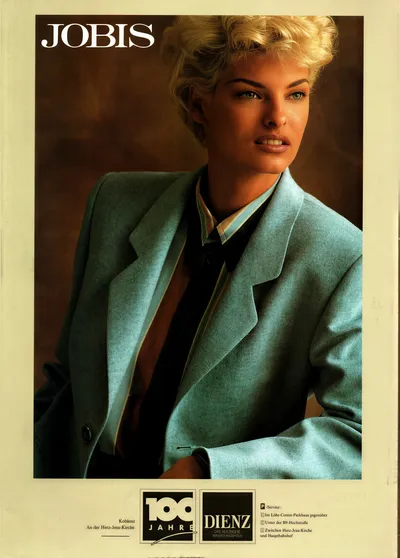 This is a vintage fashion advertisement for the brand Jobis, featuring a woman with short blonde hair wearing an oversized teal or light blue blazer jacket over a dark top and a striped collared shirt. The ad includes logos at the bottom for a retailer called Dienz, located in Koblenz, Germany, celebrating 100 years in business.