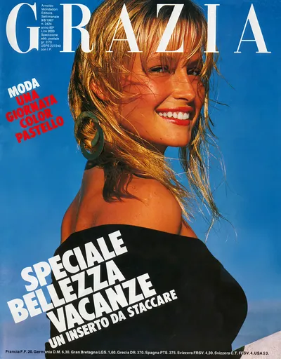 This is a magazine cover for Grazia, dated 9 August 1987, issue 2424. The cover features a woman with windswept blonde hair, red lipstick, large circular green earrings, and a black off-the-shoulder top, photographed against a bright blue sky. The cover text includes the headlines Moda Una Giornata Color Pastello and Speciale Bellezza Vacanze Un Inserto Da Staccare.