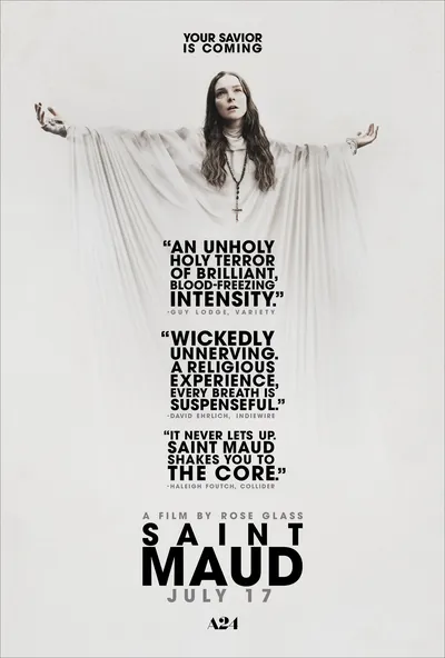 This is a movie poster for Saint Maud, an A24 film directed by Rose Glass, releasing July 17. It features a woman with long brown hair wearing a white robe and a cross necklace, posed with arms outstretched against a white background, with critic review quotes printed across the center of the poster.