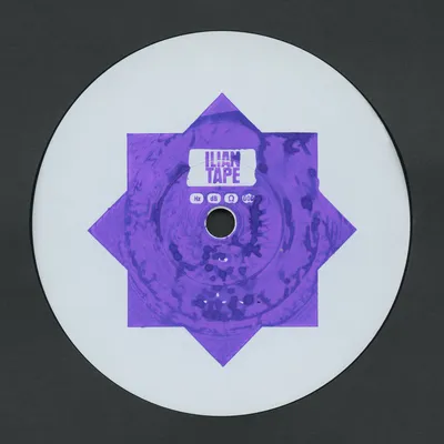 A white vinyl record label for the music imprint Ilian Tape, featuring a purple geometric star shape formed by two overlapping squares rotated 45 degrees apart, with a marbled purple texture filling the design. Small text below the label name reads Hz, dB, a symbol for ohms, and GOD.